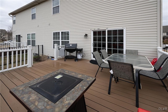 wooden terrace with outdoor dining space