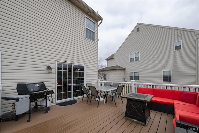 deck featuring outdoor dining area, an outdoor hangout area, and a grill