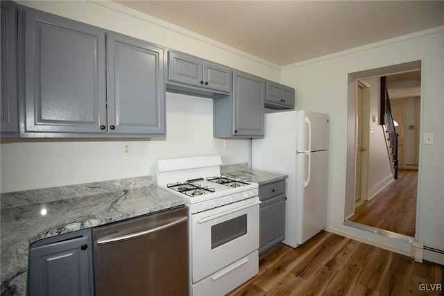 kitchen featuring white appliances, dark wood-style floors, light stone countertops, gray cabinetry, and crown molding