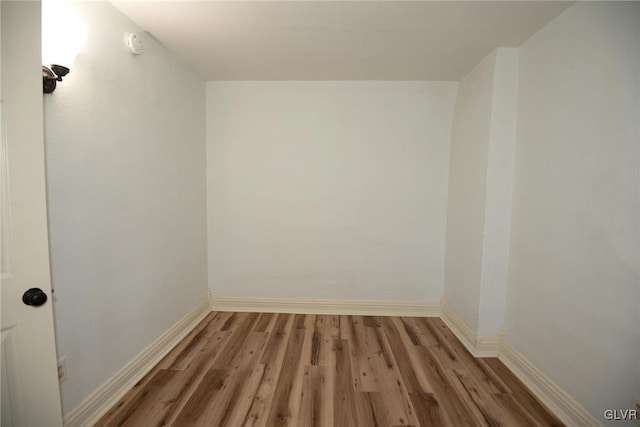 unfurnished room featuring baseboards and light wood finished floors