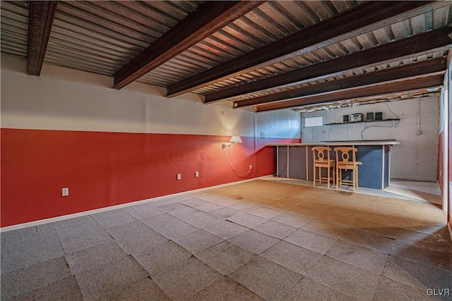 interior space featuring beam ceiling and baseboards