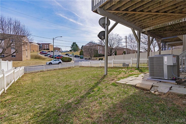 view of yard with a fenced backyard and central AC