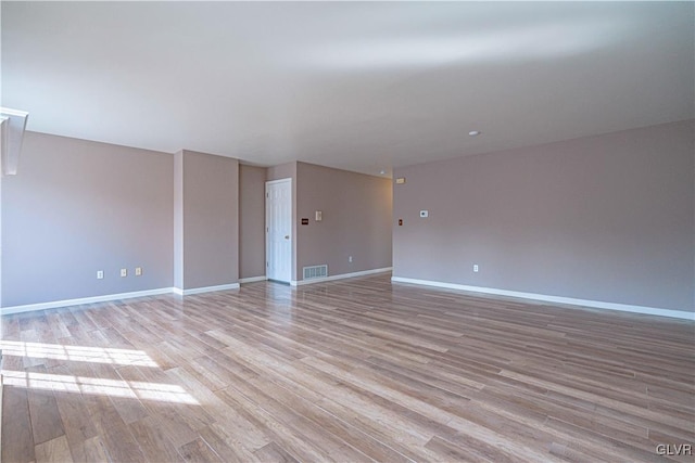 spare room with visible vents, baseboards, and light wood-style flooring