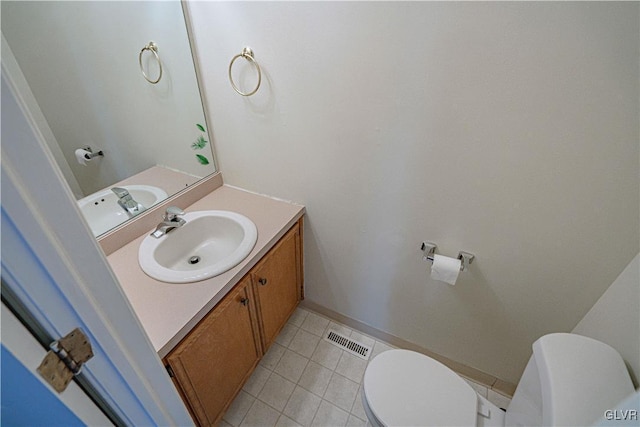 bathroom with tile patterned flooring, visible vents, toilet, and vanity