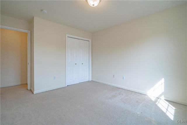 unfurnished bedroom with baseboards, a closet, and carpet floors