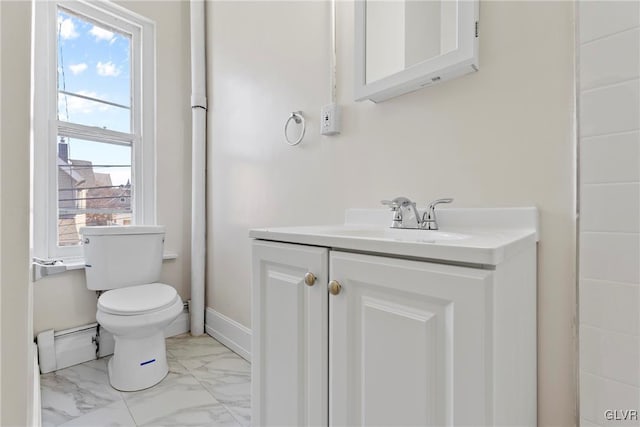 bathroom with vanity, toilet, baseboards, and marble finish floor