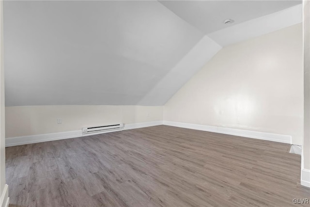 bonus room featuring vaulted ceiling, wood finished floors, baseboards, and baseboard heating