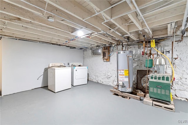 unfinished basement with washer and clothes dryer, gas water heater, and electric panel