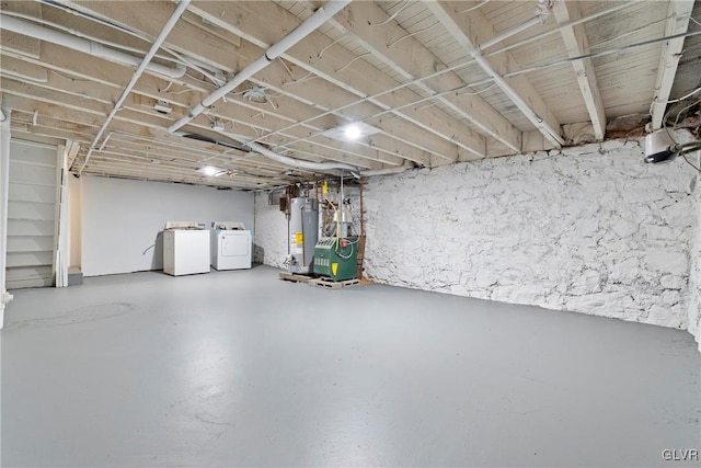 unfinished basement with independent washer and dryer and gas water heater