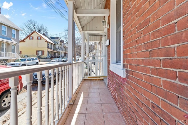 balcony with covered porch and a residential view