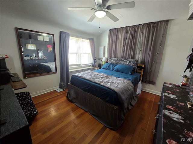 bedroom with a ceiling fan, baseboards, and hardwood / wood-style floors