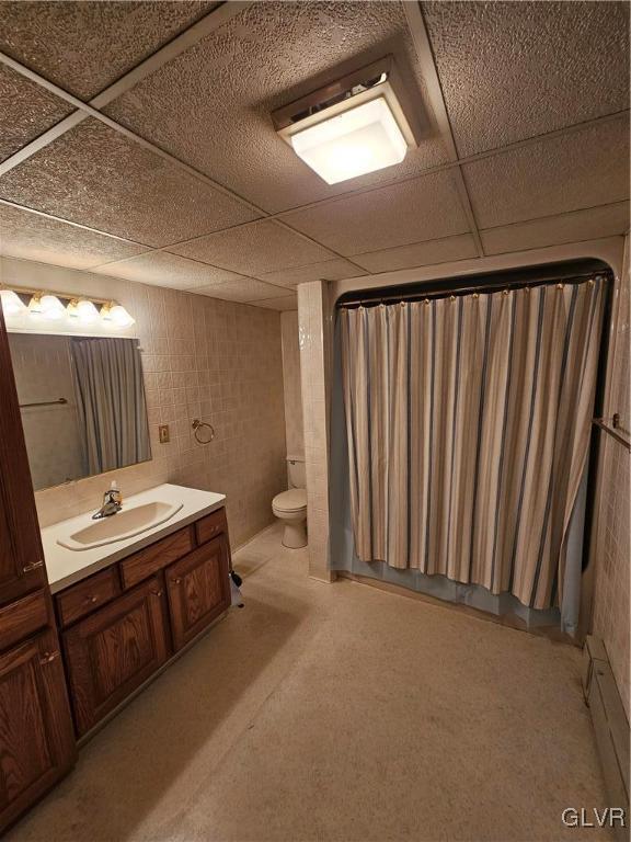 bathroom with vanity, toilet, a paneled ceiling, and baseboard heating