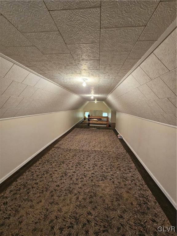 bonus room with vaulted ceiling, baseboards, and carpet floors