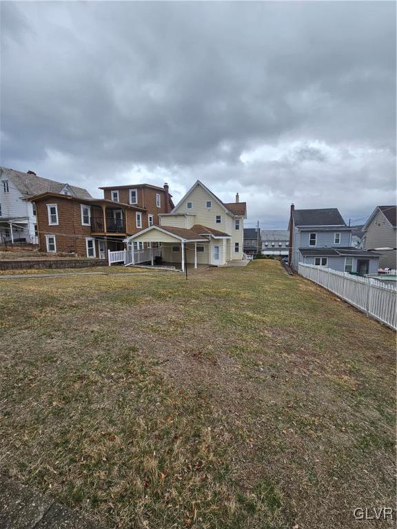 view of yard featuring a residential view and fence