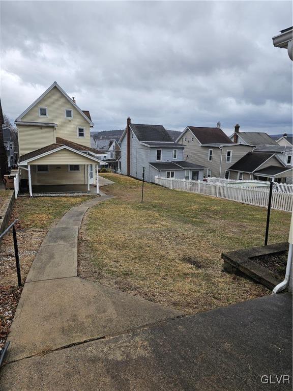 view of yard featuring a residential view and fence