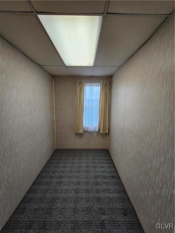 unfurnished room featuring a drop ceiling and carpet flooring