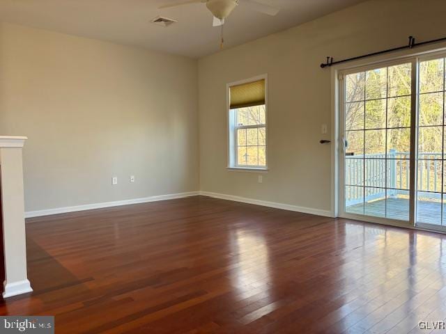 unfurnished living room featuring wood finished floors, a ceiling fan, baseboards, and visible vents