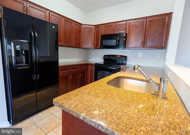 kitchen with a sink, black appliances, a peninsula, and light tile patterned floors