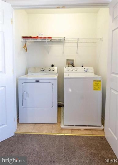 washroom featuring laundry area, light tile patterned floors, light colored carpet, and independent washer and dryer