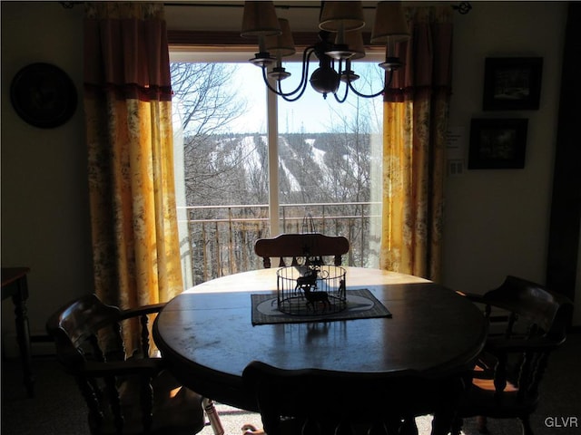 dining space with a healthy amount of sunlight and a chandelier