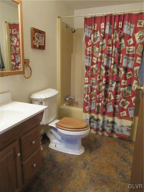 full bathroom featuring vanity, toilet, and shower / tub combo with curtain