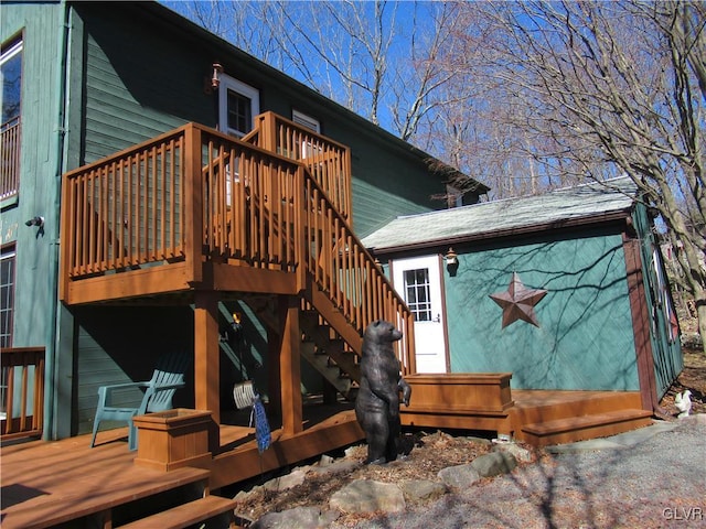 exterior space with a wooden deck, stairs, and an outdoor structure