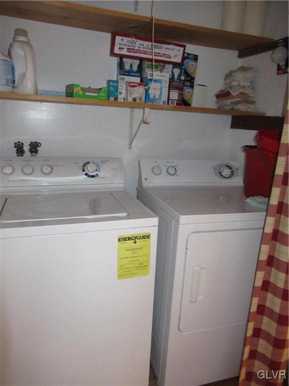 laundry area with washing machine and clothes dryer and laundry area