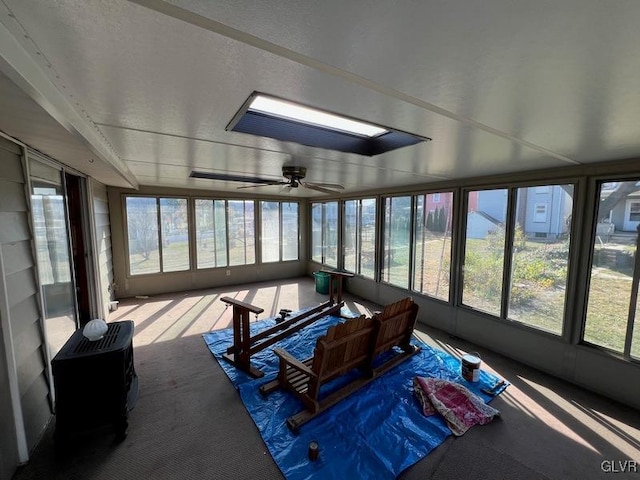 sunroom / solarium featuring ceiling fan