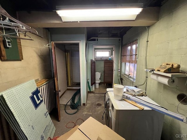 interior space with washer / clothes dryer and unfinished concrete floors