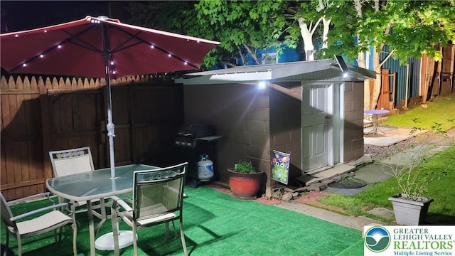 129 W Broadway, Jim Thorpe Boro, PA 18229 - view of patio featuring a storage unit, outdoor dining area, and an outdoor structure