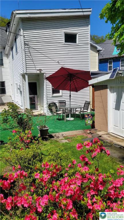 129 W Broadway, Jim Thorpe Boro, PA 18229 - rear view of house featuring a storage unit, an outbuilding, and a lawn