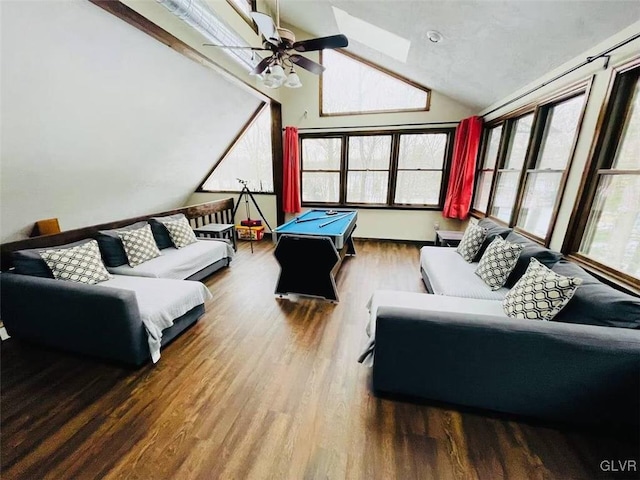recreation room featuring a ceiling fan, lofted ceiling with skylight, and wood finished floors