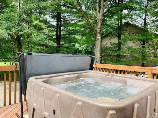 wooden deck featuring a hot tub