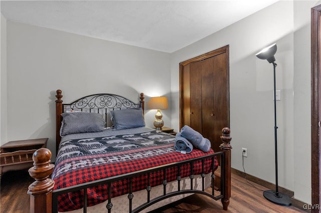 bedroom featuring baseboards and wood finished floors