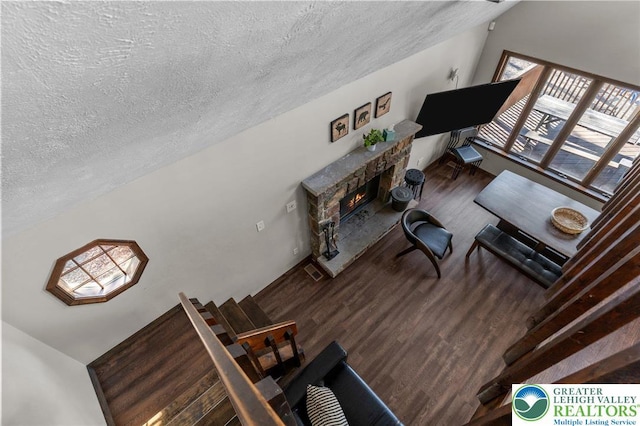 156 Poplar Pl, Tunkhannock Township, PA 18610 - living room featuring a textured ceiling, a stone fireplace, and wood finished floors