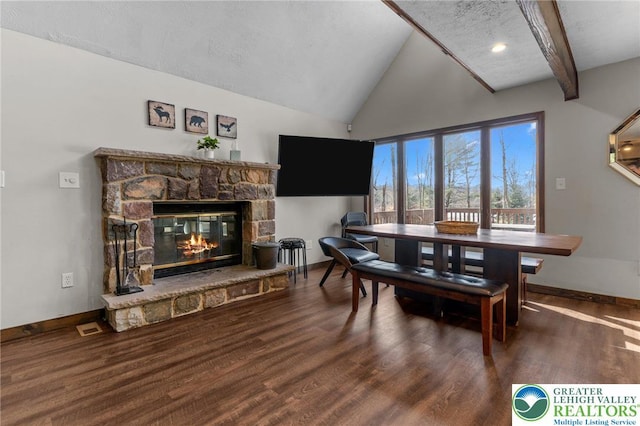 156 Poplar Pl, Tunkhannock Township, PA 18610 - dining room with a textured ceiling, a stone fireplace, baseboards, wood finished floors, and vaulted ceiling