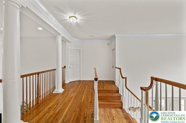 255 Rising Meadow Way E, Stroudsburg, PA 18302 - corridor with light wood finished floors, crown molding, an upstairs landing, decorative columns, and recessed lighting