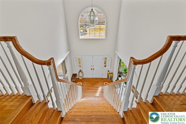 255 Rising Meadow Way E, Stroudsburg, PA 18302 - staircase with a towering ceiling and wood finished floors