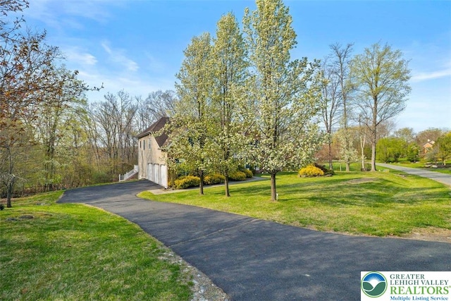255 Rising Meadow Way E, Stroudsburg, PA 18302 - view of front of house with a front yard, a garage, and driveway