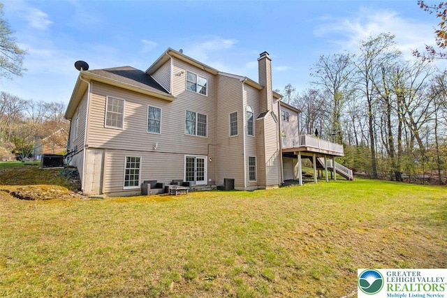 255 Rising Meadow Way E, Stroudsburg, PA 18302 - back of property with stairs, a chimney, a yard, and a wooden deck