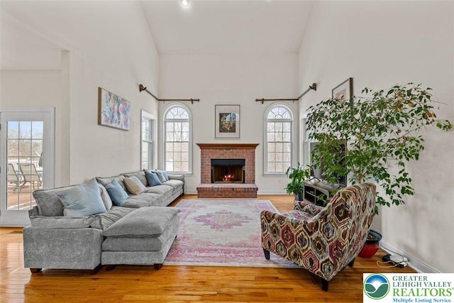255 Rising Meadow Way E, Stroudsburg, PA 18302 - living area featuring plenty of natural light, wood finished floors, a fireplace, and high vaulted ceiling
