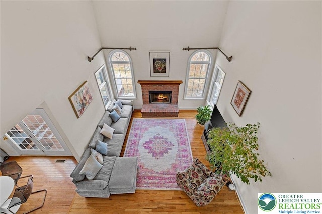 255 Rising Meadow Way E, Stroudsburg, PA 18302 - living room featuring a towering ceiling, wood finished floors, and a fireplace