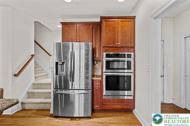 255 Rising Meadow Way E, Stroudsburg, PA 18302 - kitchen with stainless steel appliances, light wood-style flooring, brown cabinets, and recessed lighting