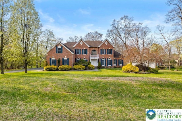 255 Rising Meadow Way E, Stroudsburg, PA 18302 - colonial-style house featuring brick siding and a front yard
