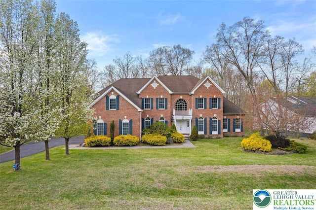 255 Rising Meadow Way E, Stroudsburg, PA 18302 - colonial house with brick siding and a front yard