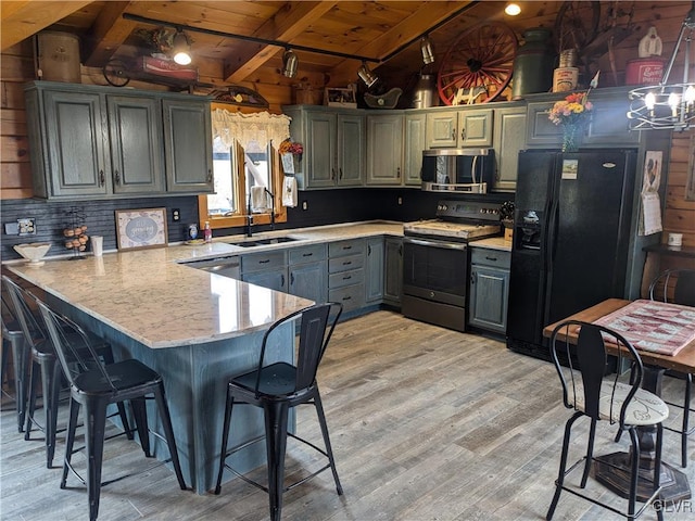2533 Williams Rd, Moore Twp, PA 18014 - kitchen with a peninsula, wood ceiling, a sink, gray cabinetry, and stainless steel appliances