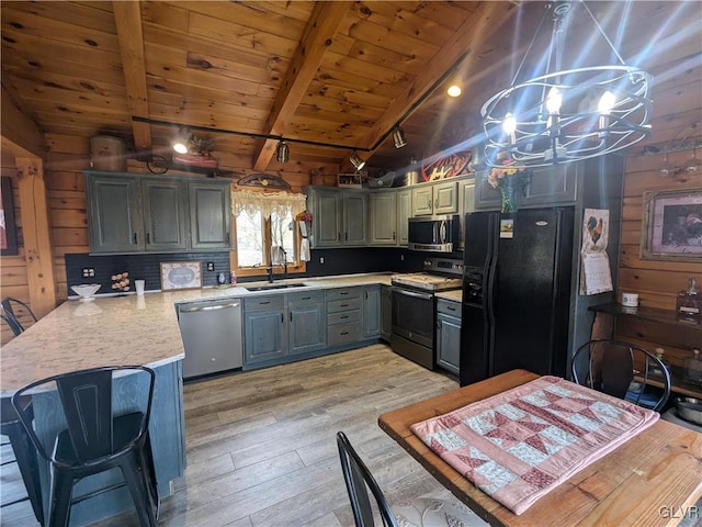 2533 Williams Rd, Moore Twp, PA 18014 - kitchen with stainless steel appliances, a peninsula, vaulted ceiling with beams, light wood-type flooring, and wood ceiling