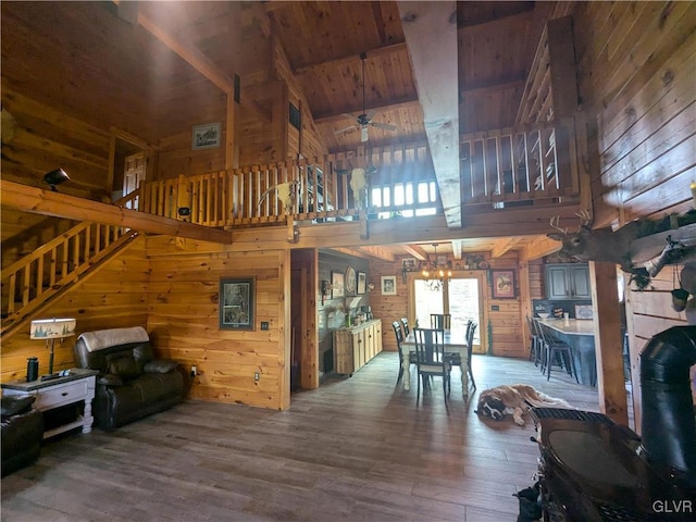 2533 Williams Rd, Moore Twp, PA 18014 - living area featuring wood walls, a towering ceiling, wood finished floors, and ceiling fan with notable chandelier