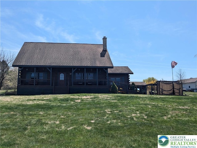 2533 Williams Rd, Moore Twp, PA 18014 - rear view of house featuring a lawn, log exterior, a chimney, and roof with shingles