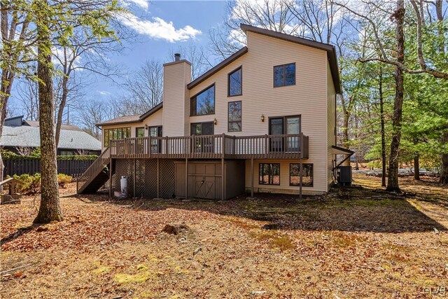 367 Saunders Dr, Lehman Twp, PA 18324 - back of property featuring a wooden deck, central air condition unit, stairway, and a chimney